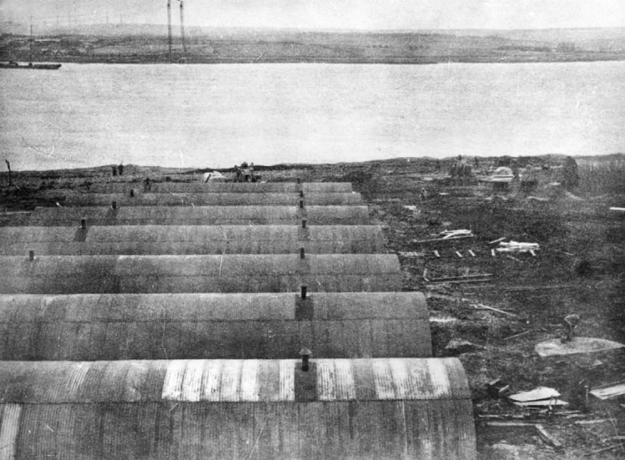 A photograph taken during the construction of the Churchill Barriers showing workers accommodation huts at Camp 60, Lamb Holm.